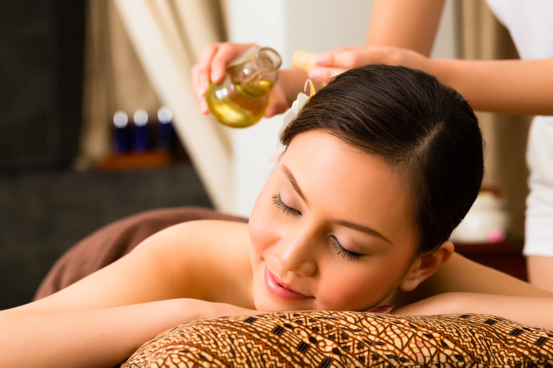 Chinese Woman at wellness massage with essential oils